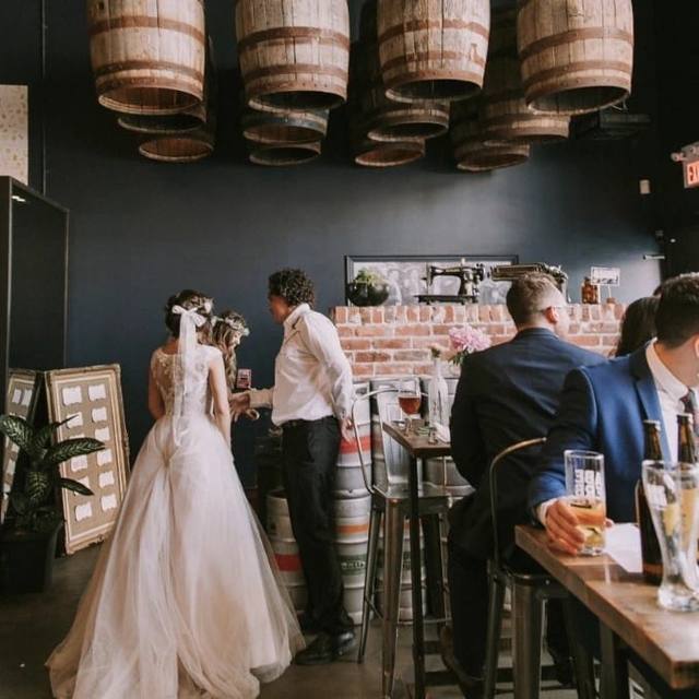 Bride and groom greeting guests at the bar