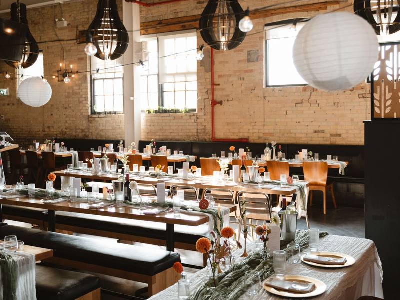 Dressed tables under pendant lights in the Downtown Kitchener dining room